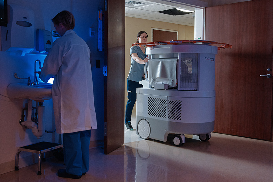 The Swoop® AI-powered portable MR imaging system moving through an ICU doorway.